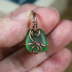 Pendant-A tiny green sea glass wrapped with copper wire