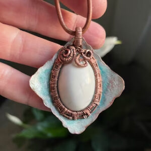 Pendant-A White Howlite cabochon wrapped with woven copper wire in a hammered copper frame