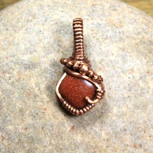 red goldstone and copper pendant