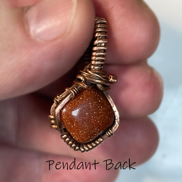 red goldstone and copper pendant