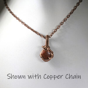 red goldstone and copper pendant