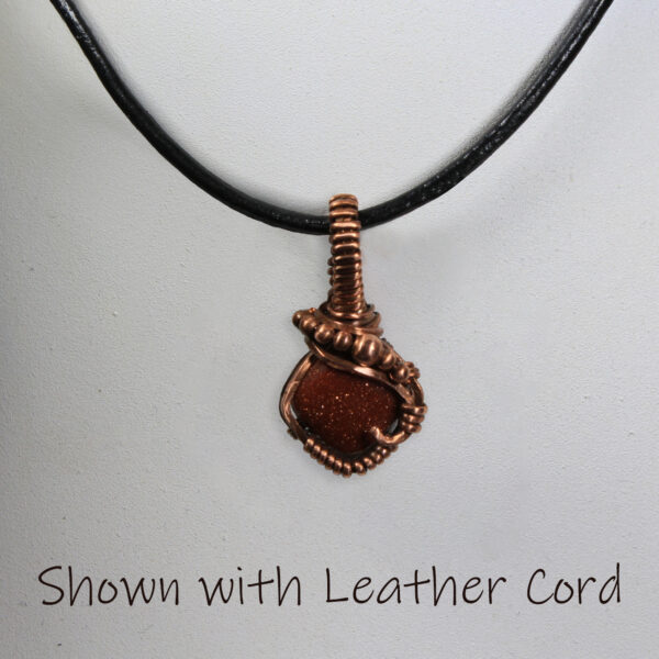 red goldstone and copper pendant